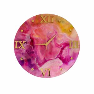 A round, handmade resin art wall clock featuring an abstract swirl of pink, purple, and